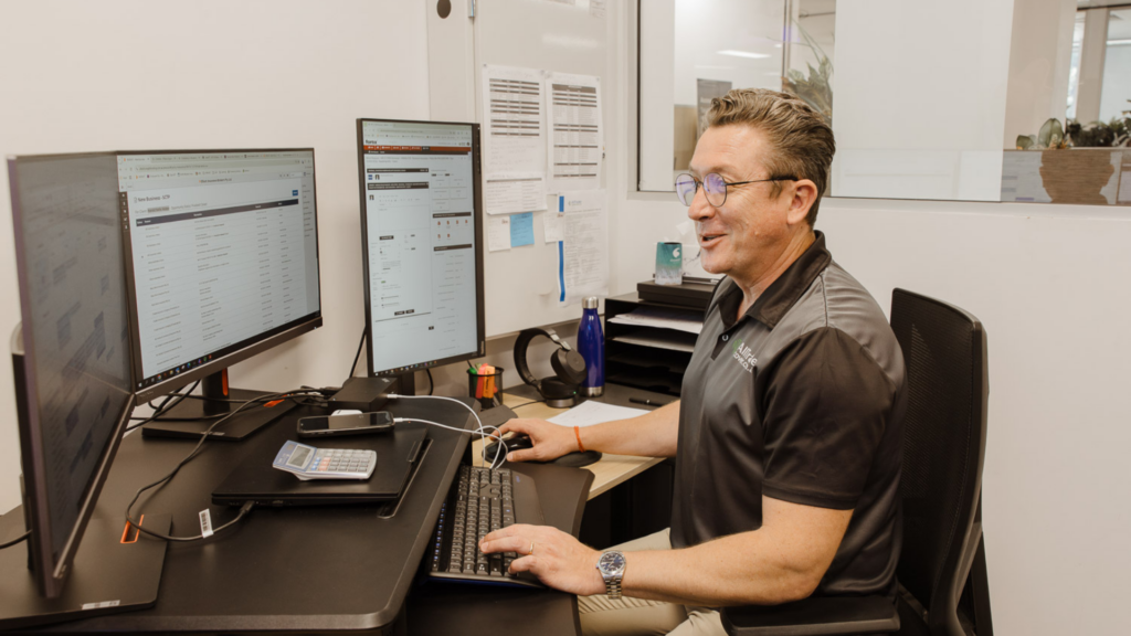 A Fortix client sitting at their desk, using their systems.